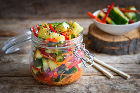 Vegetable salad in a glass jar. wooden backgroundの写真素材