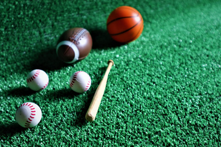Active recreation. Sports Equipment. Basketball, football, rugby and baseball on green background