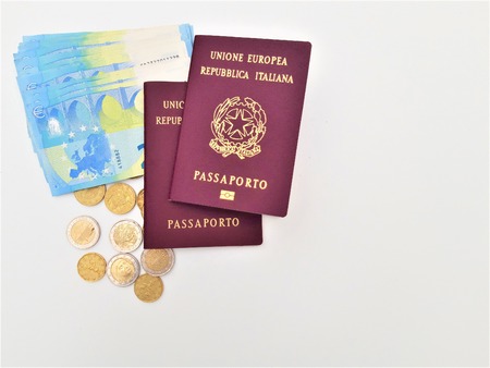 Two italian passport with Euro banknotes over white background.の写真素材