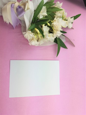 Bouquet of white flowers on pink background. Top view. Flat lay. Copy space. Valentines day, mothers day, birthday, wedding celebration conceptの写真素材