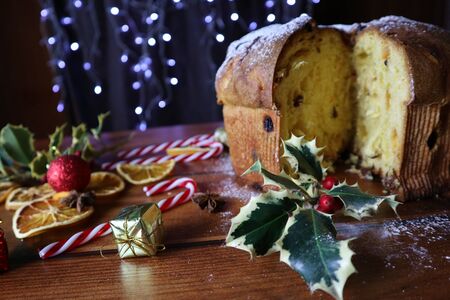 traditional italian christmas cupcake panettonePanettone Christmas sweet. Italian Christmas cupcake with powdered sugar on a  wooden background.の写真素材