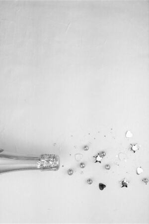 Creative concept photo of champagne bottle with confetti on  background.の写真素材
