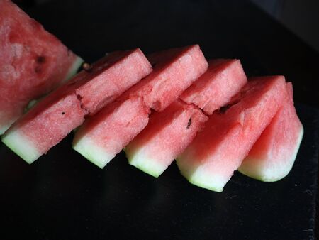 red sweet watermelon sliced on black background