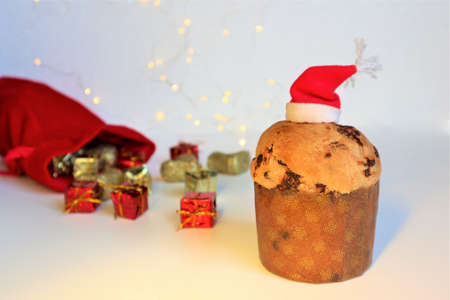 Christmas greeting card. Italian Christmas sweet (panettone) with colorful gifts on white background. Christmas or New Year celebration concept. Copy spaceの写真素材