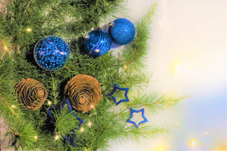 Christmas background of green tinsel in the form of fir branches and balls Christmas background with...