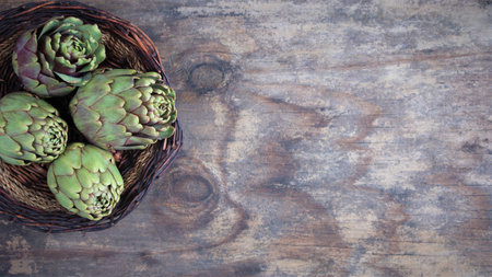 artichokes on a wooden background. view from above. Copy space banner. flat lay