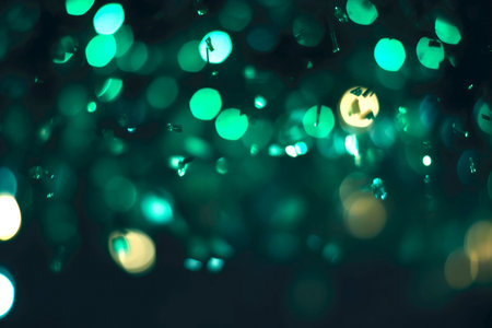 sparkling sparkler in the green area. sparkler fire with blurred bokeh background. new year or St. Patrick's Day.の素材