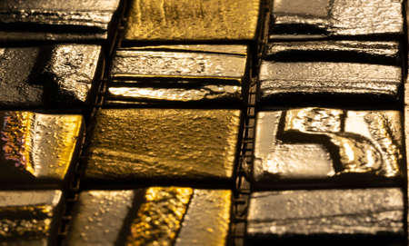 Metallic gold and black colored shiny glossy glass mosaic tile backgroundの写真素材