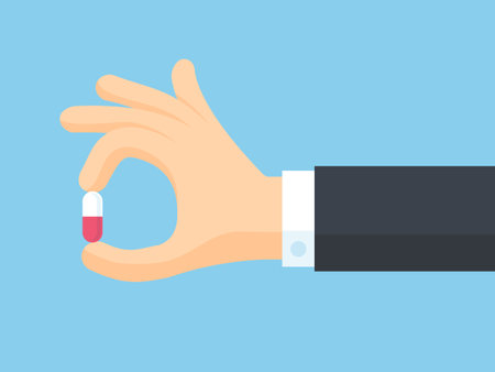 Hand holding a red pill. Vector illustration in flat design style.のイラスト素材