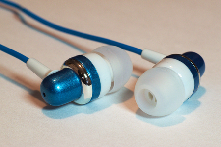 BLUE AND WHITE HEADSET FOR SMARTPHONE IN CLOSEUPの写真素材
