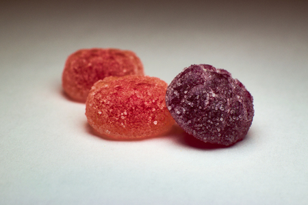 three chewy candies in the foregroundの写真素材