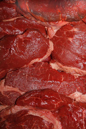 close up image of raw rump steaks in fridgeの写真素材