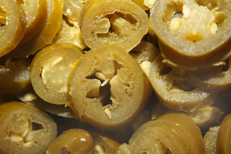 close up image of green jalepenos in tubの写真素材
