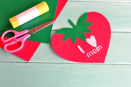 Greeting card mother's day with words I love mom. Happy mother's day. Kids crafts. Paper sheets, glue, scissors - set for children's artの写真素材