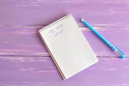 Open paper notebook with message My diet plan. Notepad to plan weight loss. Blue pen. Planning...