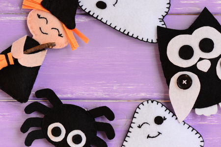 Quick Halloween crafts. Felt witch, ghosts, owl, spider decor on a wooden table. Felt Halloween handmade decor set. Easy sewing pattern for adults and kids. Top viewの写真素材