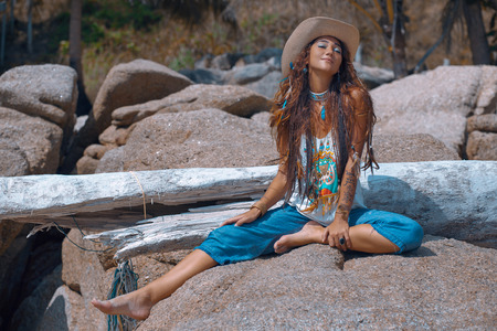 Happy summer girl sitting on the stone. Boho styleの写真素材