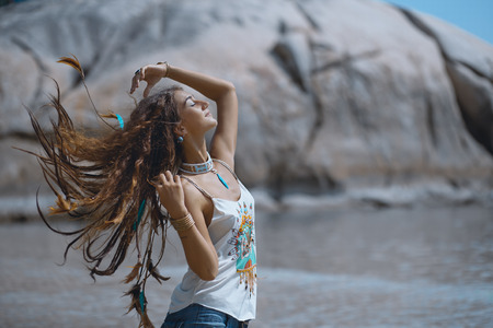 Attractive boho woman on the beach