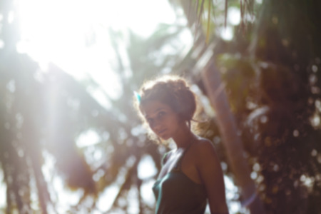 Blurry image of beautiful young woman outdoorsの写真素材