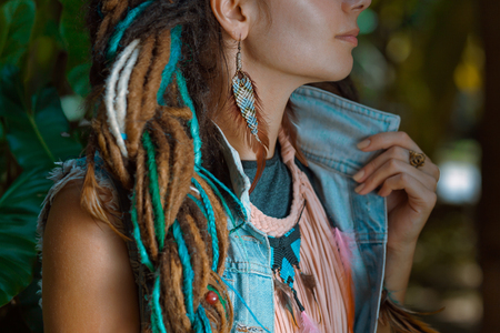 close up photo of hippie girl wearing denim jacket with dreadlockの写真素材