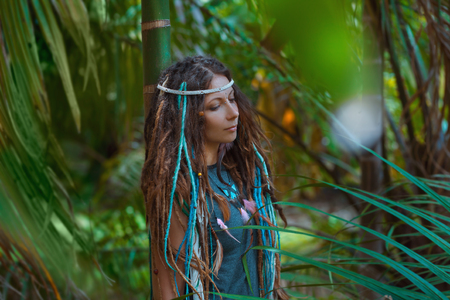 portrait of young caucasian woman in jungle forestの写真素材