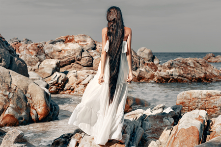 beautiful young boho style woman in white dressの写真素材