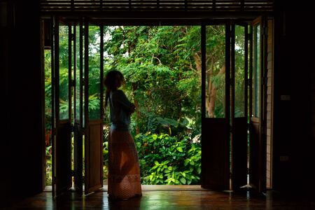 young woman silhouette with tropical backgroundの写真素材