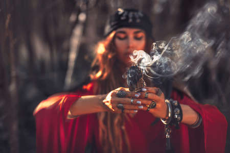 close up of woman hands with shamanic fire outdoorsの写真素材