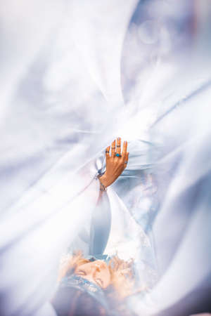 beautiful young woman with blue fabric. top view