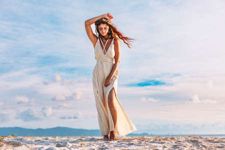 beautiful young woman on the beach at sunset