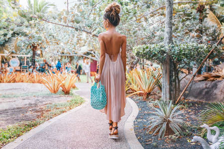 beautiful young stylish woman at tropical resort