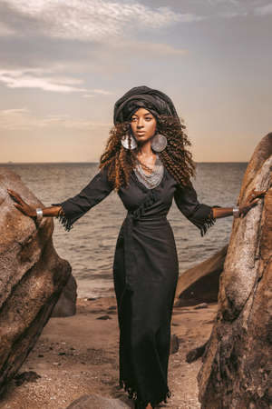 beautiful young tribal woman with wearing turban outdoors portraitの写真素材