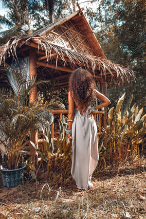 beautiful stylish woman having fun outdoors  from backの写真素材