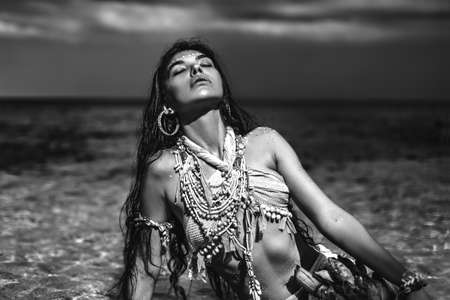 Beautiful young wild woman on the beach
