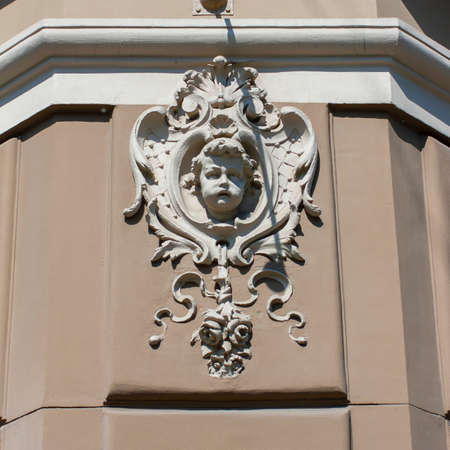 Mascaron in the form of a female head on the facade of a 19th-century house in the style of Vienna...