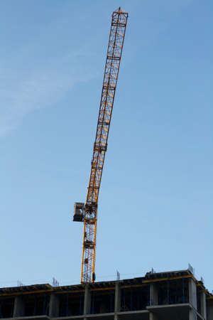 Construction crane on the construction of a buildingの写真素材