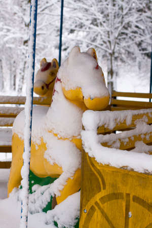 Attraction with horses on? Musement park. The first snow. Winterの写真素材