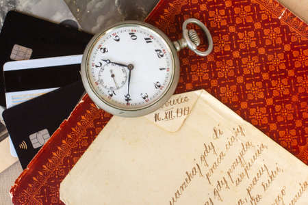 Antique items with bank cards. 19th century pocket watch and antique lettering. Antique trade. Vintage background.の写真素材