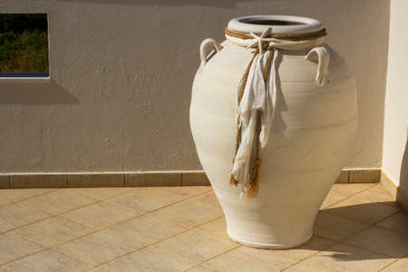 White amphora decorated with fabric. Greek theme.の写真素材