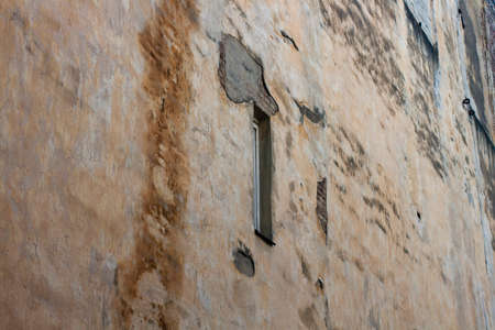 background. Texture of the old brick wall of the old building of the 19th century with a narrow...