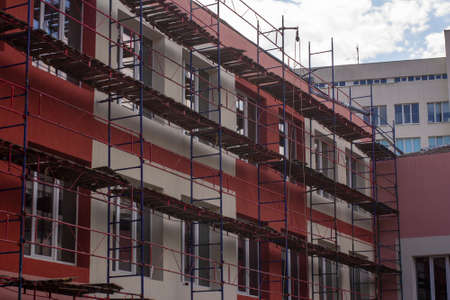 Scaffolding for painting the facade of a two-story house
