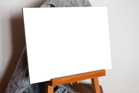 Blank horizontal picture without frame on little easel. Place to insert a pictureの写真素材