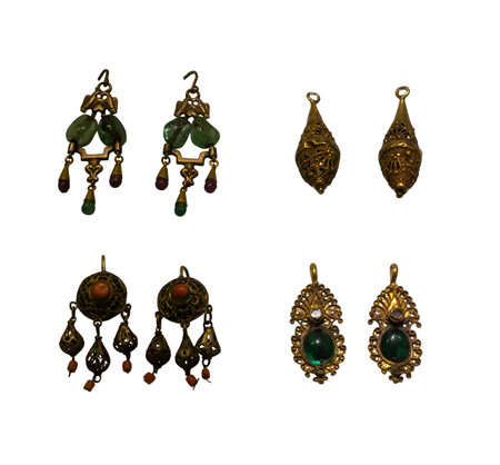 Gold earrings with precious stones isolated on white background. Period of Ancient Romeの写真素材