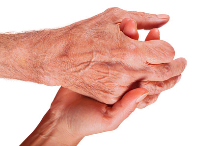 Young woman hand holding elderly man hand with amputated finger on white background.の写真素材
