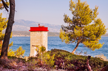 Port beacon sea light on coast close to Rab island.の写真素材
