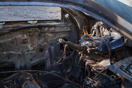 Closeup interior photo of a burnt out car wreck, fire damage.の写真素材