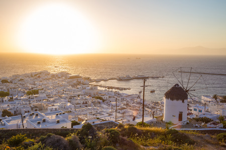Mykonos town with windmill at sunの写真素材