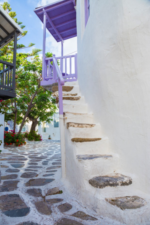Mykonos street view with white stairs, trees and purple balcony, Greeceの写真素材