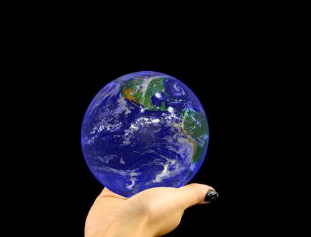 blue globe lying on a woman's hand on a black background. Image of earth used under Terms and Conditions of Nasa http://visibleearth.nasa.govの写真素材
