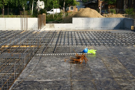 Abandoned blue helmet lying on a formwork with reinforcementの写真素材